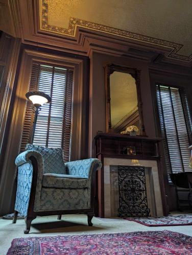 a living room with a chair and a mirror at The Vistula Rose B & B in Toledo