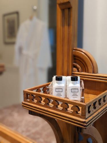 a wooden table with two bottles of moisturizers in front of a mirror at The Vistula Rose B & B in Toledo