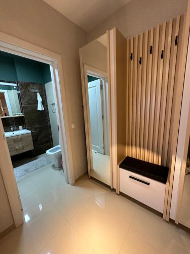 a bathroom with a toilet and a sink and a mirror at Complex Rediu 54 Luxury Apartaments in Iaşi