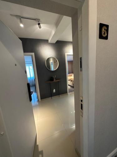 a hallway leading to a bedroom with a mirror at Complex Rediu 54 Luxury Apartaments in Iaşi