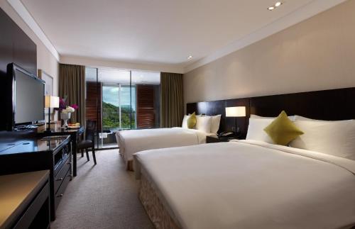 a large hotel room with two beds and a television at RSL Cold & Hot Springs Resort Suao in Suao