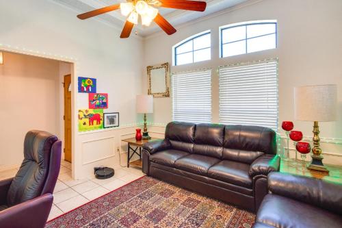 a living room with a leather couch and chairs at Charming Texas Escape, Near Cedar Hill State Park! in Duncanville