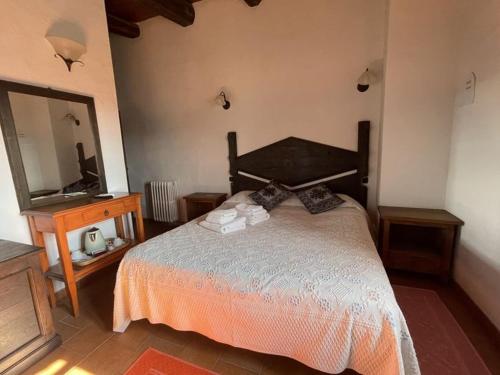 a bedroom with a bed and a dresser and a mirror at Agriturismo Il Muto di Gallura in Aggius