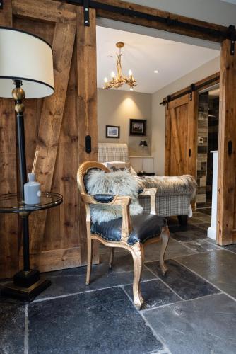 a living room with a chair and a lamp at Gileston Manor-Self catering in Saint Athans