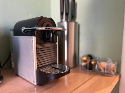 a coffee maker sitting on top of a wooden table at Studio - La parenthèse Valognaise in Valognes