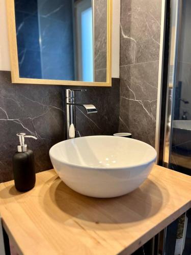 a white bowl sink on a counter in a bathroom at Studio - La parenthèse Valognaise in Valognes
