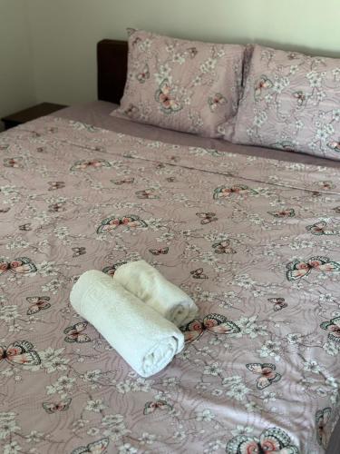 a rolled up towel sitting on top of a bed at Apartments Airport Golubovci in Podgorica