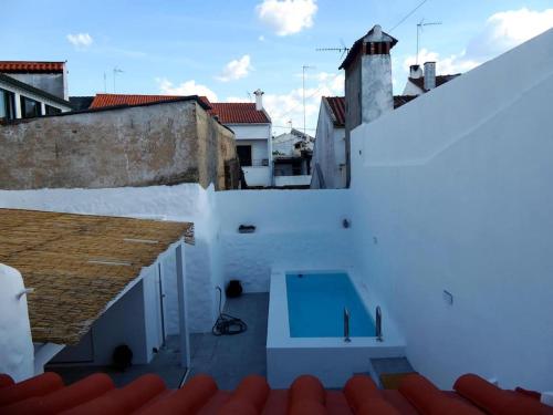 a view of a white building with a blue door at Casas do Gavião by Portus Alacer in Gavião