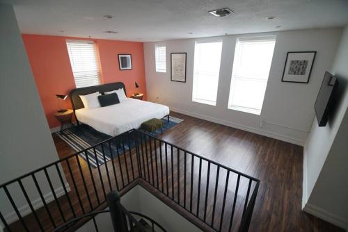 a bedroom with a bed and two windows at The Lofts on Clematis 309 Downtown West Palm Beach in West Palm Beach