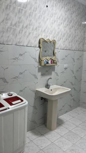 a white bathroom with a sink and a counter at شقة مفروشة للايجار فندقية عباس العقاد in Cairo