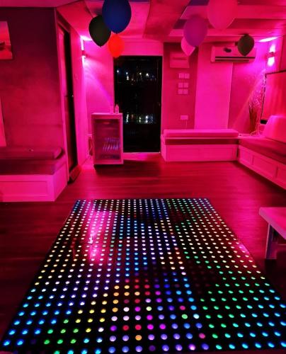 a room with pink and blue lights on the floor at Party boat in Abu Dhabi