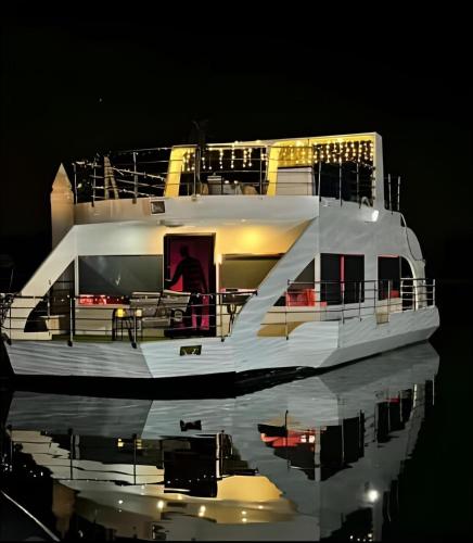 a large white boat in the water at night at Party boat in Abu Dhabi