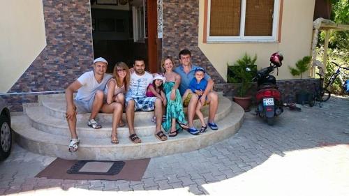 a group of people sitting on a stone bench at Hotel Grün in Kızılot