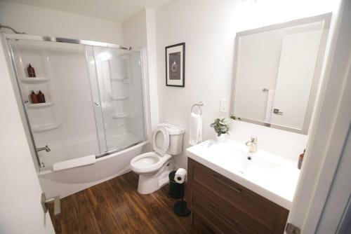 a bathroom with a shower and a toilet and a sink at The Lofts on Clematis 504 Downtown West Palm Beach in West Palm Beach