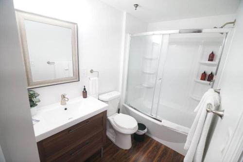 a bathroom with a shower and a toilet and a sink at The Lofts on Clematis 508 Downtown West Palm Beach in West Palm Beach