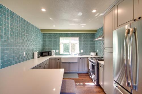 a kitchen with white appliances and blue tiles at Running Springs Cabin with Spacious Deck and Hot Tub! in Running Springs