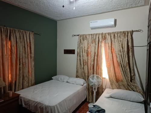 a bedroom with two beds and a window at Hotel Bethlehem in La Lima