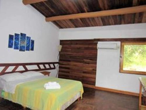 a bedroom with a bed and a window in it at HOTEL LA TOSCANA in San Ignacio