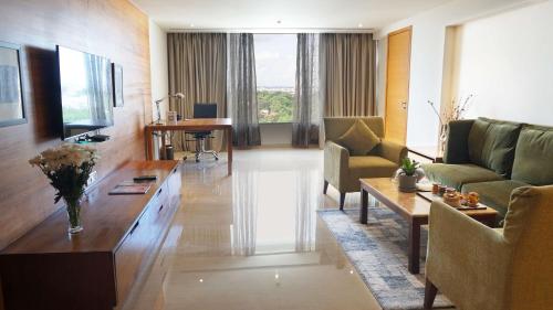a living room with a couch and a table at Radisson Blu Plaza Hotel Hyderabad Banjara Hills in Hyderabad