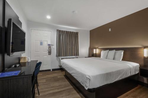 a hotel room with a bed and a television at Suites Escondido CA in Escondido