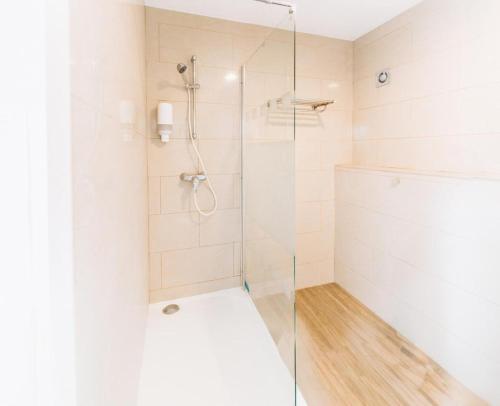 a bathroom with a shower with a glass door at Atomihotel: Contemporary Comfort Steps from the Atomium! in Brussels