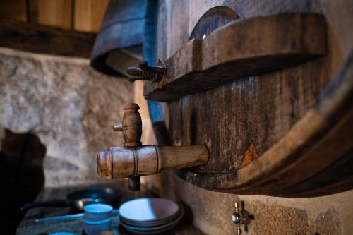 a kitchen sink with a copper faucet on a wall at Casa dos do Carvalho - Miradouro da Branda in Branda de Santo António