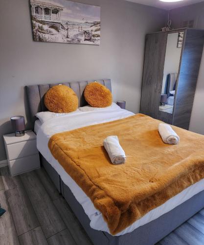 a bedroom with a large bed with two pillows on it at Stunning 3 bedroom FMHomes & Apartments in Uddingston