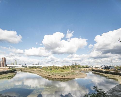 a view of a river with clouds in the sky at Stunning Riverside View Apartment, near Canary Wharf & O2 in London