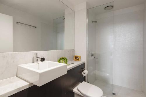 a bathroom with a sink and a toilet and a shower at Urban Oasis in the Heart of Richmond Cultural Hub in Melbourne