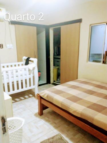 1 dormitorio con 1 cama y 1 cuna en una habitación en João Carlos Lima de Brito, en Olinda