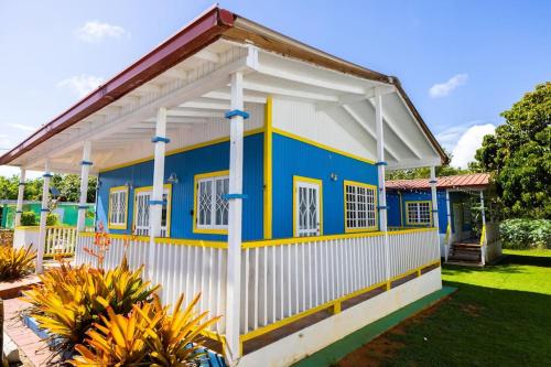 a blue and white house with a white at Jobos Beach Apt #1 near food truck and beach . in Isabela