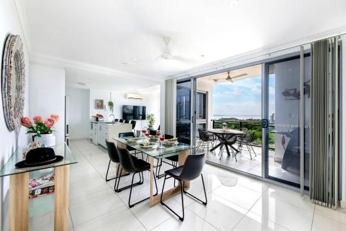 a kitchen and dining room with a glass table and chairs at 'Top of Town' Resort-style Stay in Heart of Darwin in Darwin