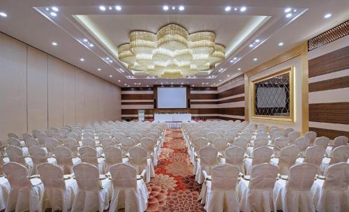 a room with rows of chairs and a screen at Sayaji Kolhapur in Kolhapur