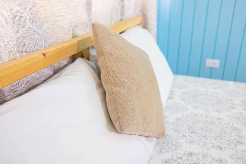 a bed with two pillows on top of it at Jobos Beach Apt #2 near food truck and beach in Isabela