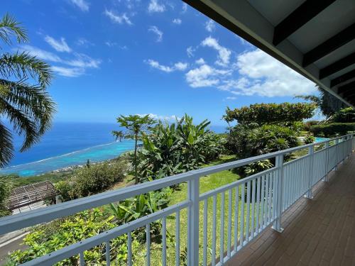 a balcony with a view of the ocean at Villa Te Miti in Punaauia