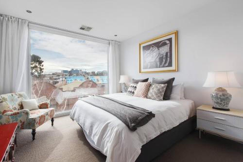 - une chambre avec un lit et une grande fenêtre dans l'établissement Richmond Japanese-Style Townhouse close to MCG, à Melbourne