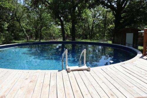 a large swimming pool with a wooden deck at Blue Door Farmhouse in Meeker