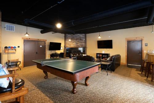 a room with a ping pong table in it at Penthouse Studio w Mtn Sunrise Views & Near Silver Mtn in Kellogg