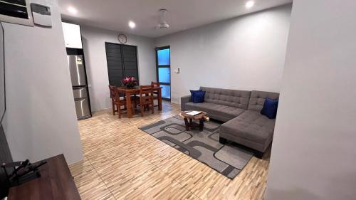 a living room with a couch and a table at GreyStone Apartments in Nadi