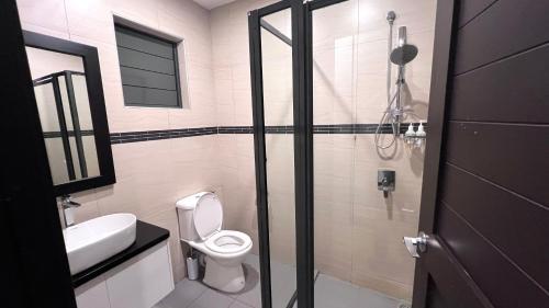 a bathroom with a toilet and a sink and a shower at GreyStone Apartments in Nadi
