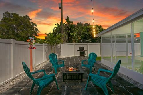 a group of chairs sitting around a fire pit on a patio at 5 min Beaches~Mini Golf~Pool Table~Pets~KING BED + in Largo