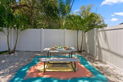 a table in a backyard with a fence at 5 min Beaches~Mini Golf~Pool Table~Pets~KING BED + in Largo