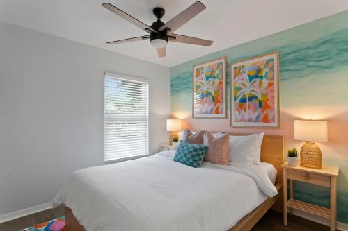 a bedroom with a white bed with a ceiling fan at 5 min Beaches~Mini Golf~Pool Table~Pets~KING BED + in Largo