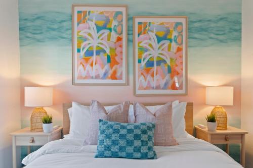 a bedroom with a bed with two pictures on the wall at 5 min Beaches~Mini Golf~Pool Table~Pets~KING BED + in Largo