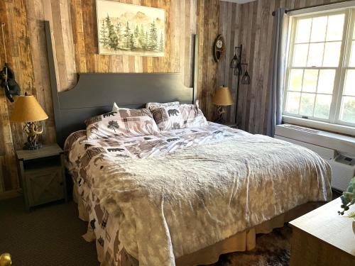 a bedroom with a large bed and a window at Gorgeous 1st FL Mtn View Jiminy Suite Sleeps 4 Ski On Off in Hancock
