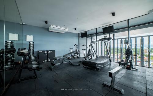 a gym with cardio equipment in a building at Mercure Miri City Centre in Miri