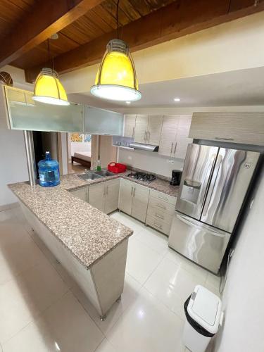 a kitchen with a stainless steel refrigerator and a counter at Edificio Bahia Fragata Apartamento 411 in San Andrés