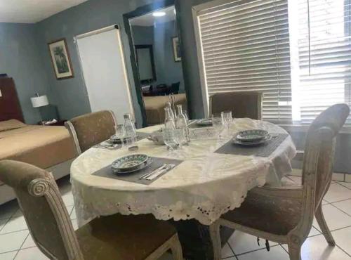 a dining room table with a white table cloth on it at Presidential Suite in Tijuana