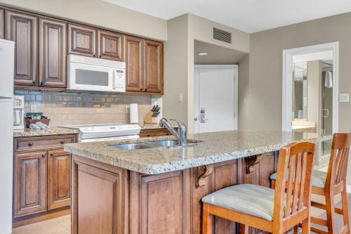 a kitchen with wooden cabinets and a counter top at Spacious Hideaway in Nature in Edgar
