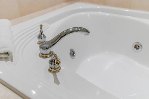 a white bath tub with a silver faucet at Spacious Hideaway in Nature in Edgar